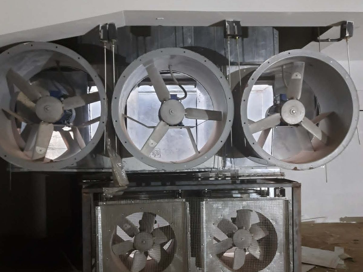 Axial fan bank above an air handling unit