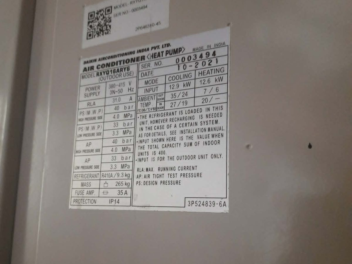Outdoor unit nameplate showing capacity and refrigerant charge